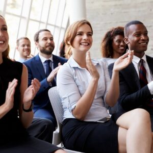 Adult students applauding at the end of a presentation.