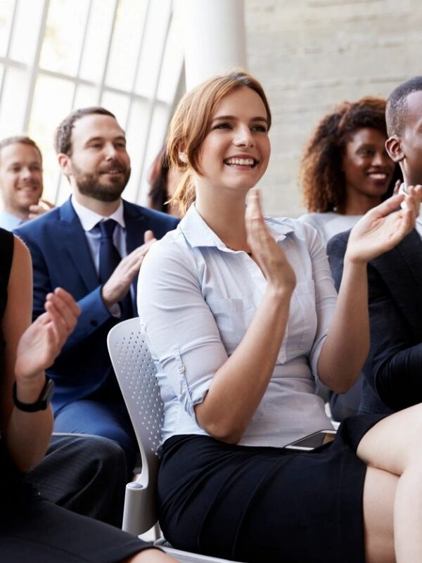 Adult students applauding at the end of a presentation.